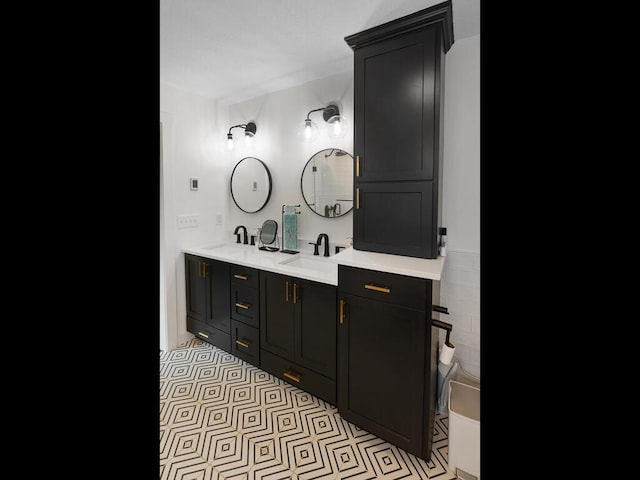 full bath with double vanity, a sink, and tile patterned floors