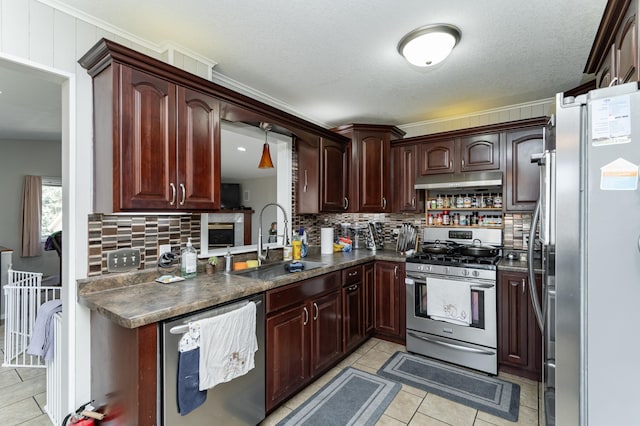 kitchen featuring a sink, tasteful backsplash, dark countertops, and stainless steel appliances