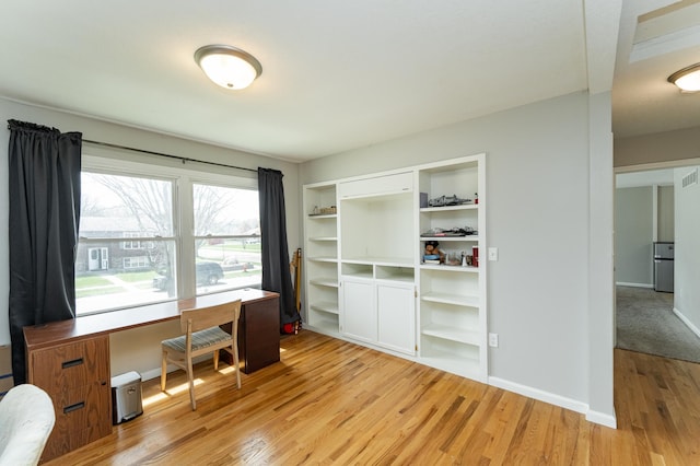 office space featuring baseboards, visible vents, and light wood-style flooring