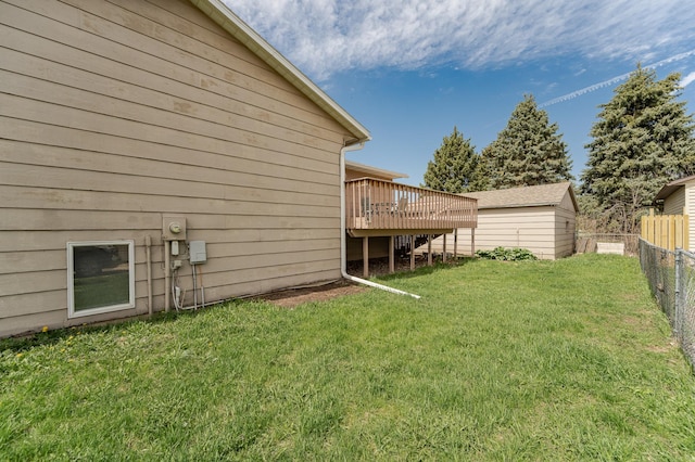 view of yard featuring fence and a wooden deck