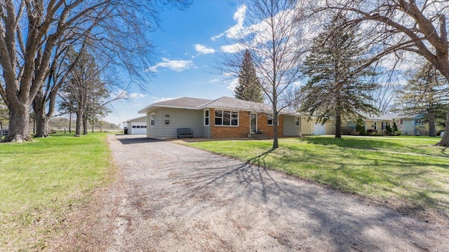 ranch-style house with driveway, a front lawn, and a garage