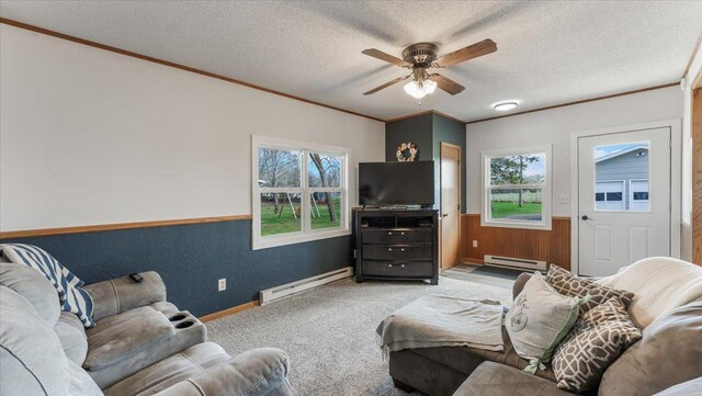 living room with a ceiling fan, a textured ceiling, baseboard heating, and carpet
