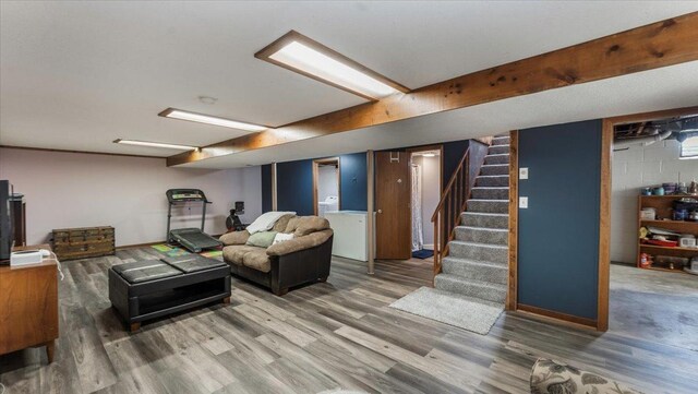 living room featuring wood finished floors and stairway