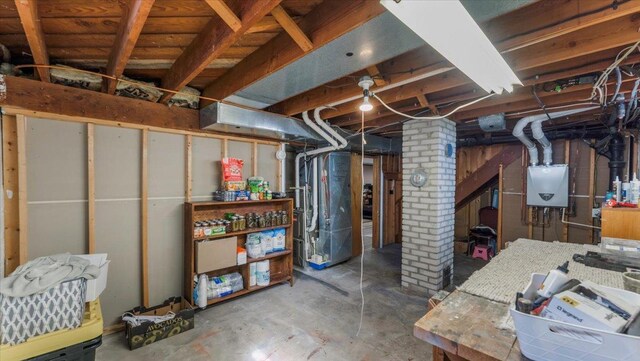 unfinished below grade area featuring water heater and refrigerator