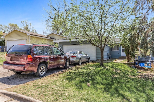 360 Hawthorne Ave E, Saint Paul, MN 55130 - view of front of home with aphalt driveway, an attached garage, and a front lawn