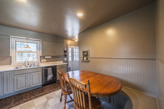 dining space with a wainscoted wall and recessed lighting