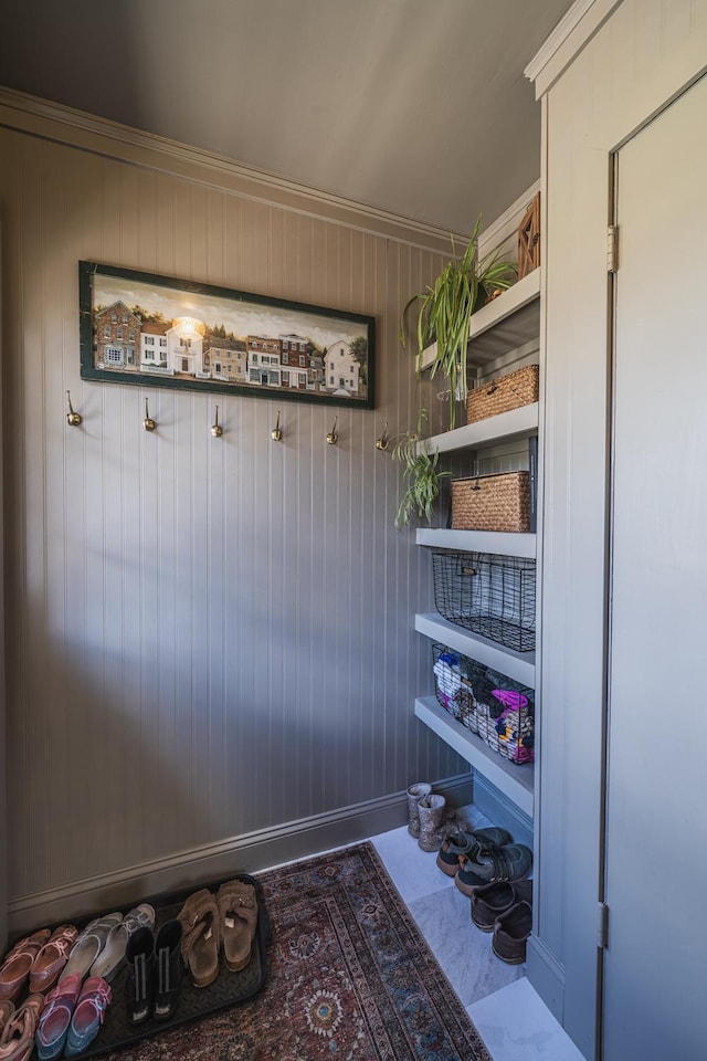 mudroom with wooden walls