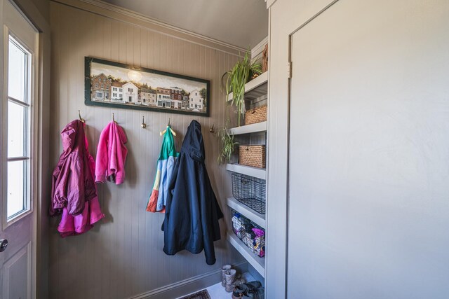 mudroom with wood walls