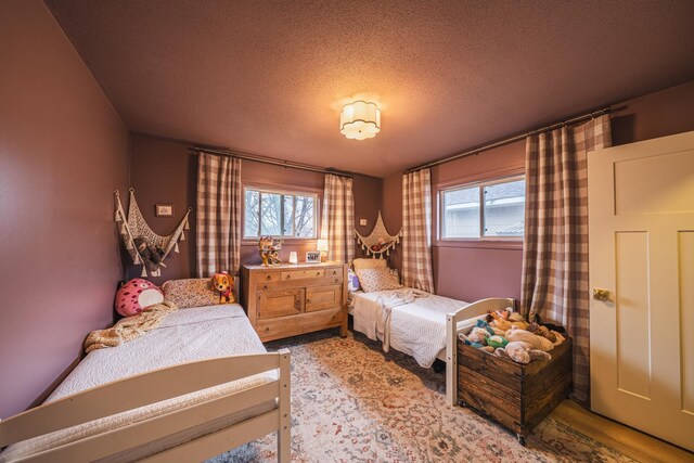 bedroom with multiple windows and a textured ceiling