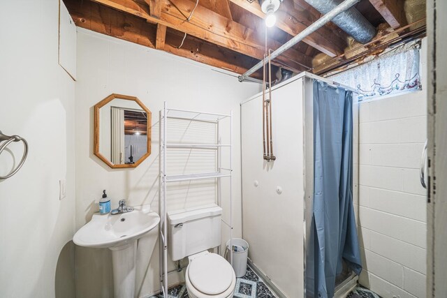 full bath featuring toilet and a stall shower