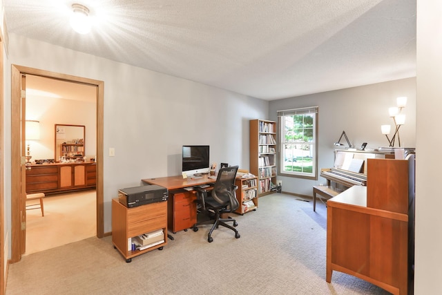 home office featuring a textured ceiling and light carpet