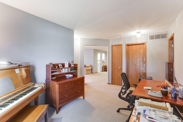 office space with visible vents and light carpet