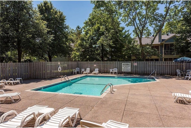 pool featuring a patio and fence