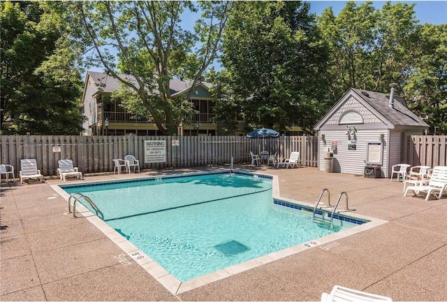 pool with a patio and fence
