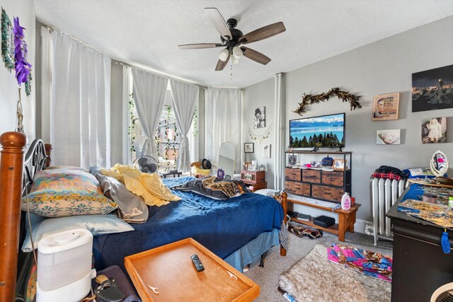 bedroom featuring carpet floors, a textured ceiling, ceiling fan, and radiator