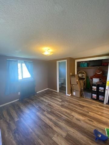 528 Broadway St, Spring Valley, MN 55975 - interior space featuring a textured ceiling, baseboards, and wood finished floors