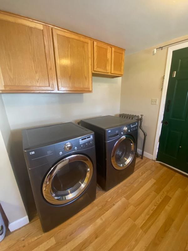 528 Broadway St, Spring Valley, MN 55975 - washroom featuring baseboards, light wood finished floors, independent washer and dryer, and cabinet space