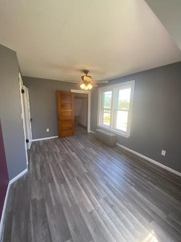 528 Broadway St, Spring Valley, MN 55975 - unfurnished living room featuring ceiling fan, baseboards, and dark wood finished floors