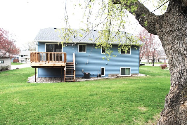 back of house featuring central AC, a wooden deck, roof with shingles, a yard, and stairway