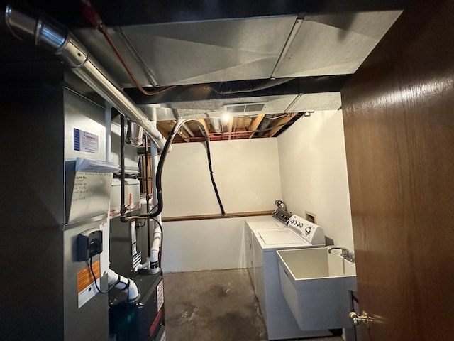 laundry room featuring laundry area, a sink, washer and clothes dryer, and visible vents