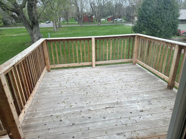 wooden deck featuring a yard