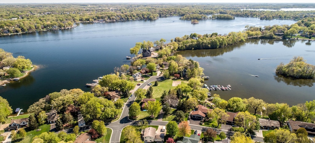 drone / aerial view featuring a water view and a forest view