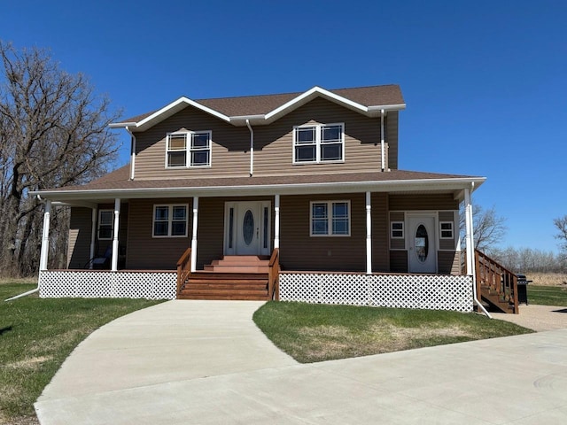 country-style home with a front lawn and covered porch