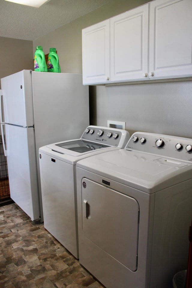 laundry area featuring independent washer and dryer and cabinet space