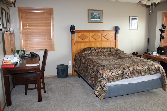 bedroom with baseboards and carpet