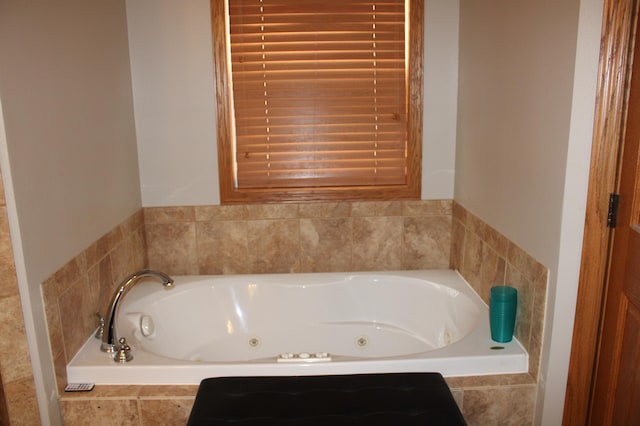 bathroom with a tub with jets