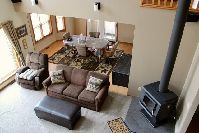 living room featuring visible vents and a wood stove