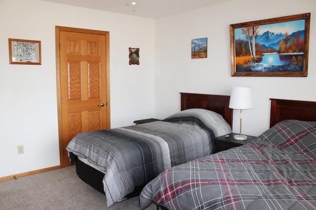 bedroom featuring baseboards and carpet