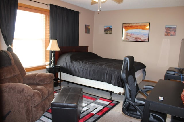 bedroom featuring baseboards, carpet, and multiple windows