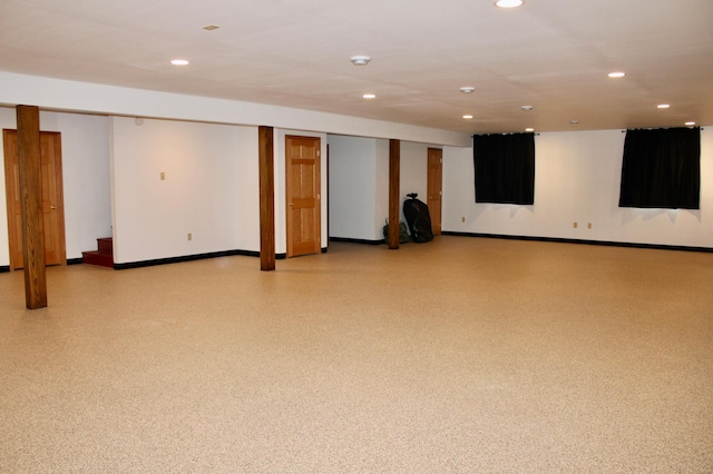 finished below grade area featuring recessed lighting, baseboards, and stairway