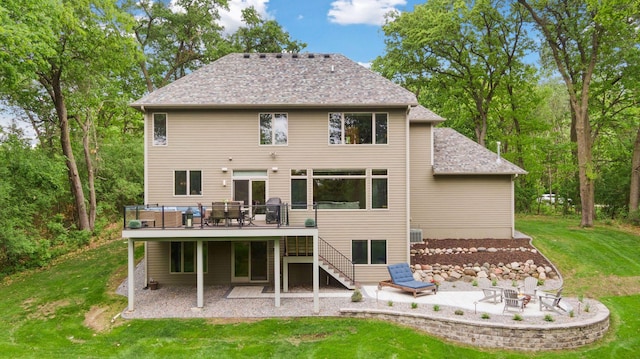 rear view of house with a deck, an outdoor fire pit, a patio, and stairs