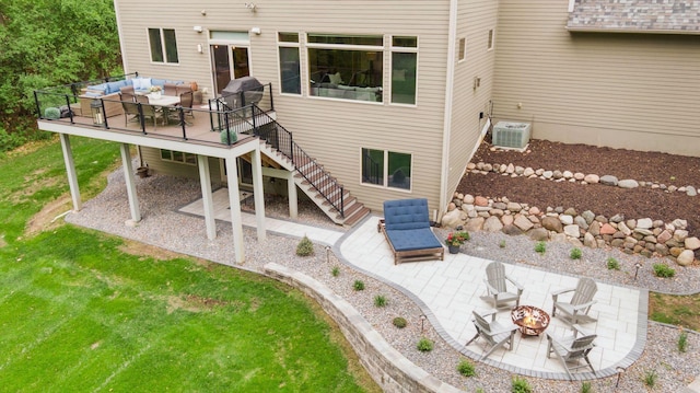 back of house with a deck, an outdoor fire pit, a patio, stairway, and outdoor dining area