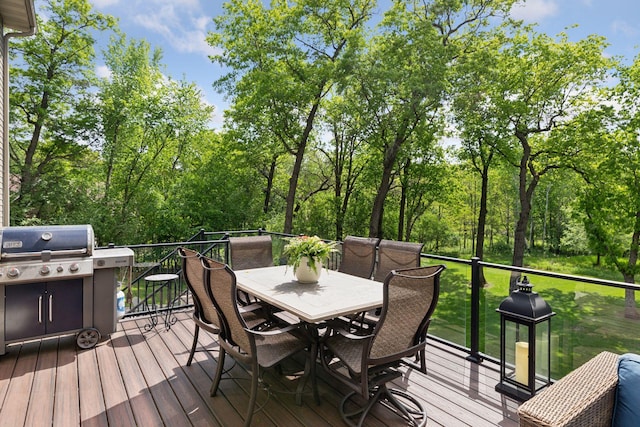 wooden terrace featuring outdoor dining area and grilling area