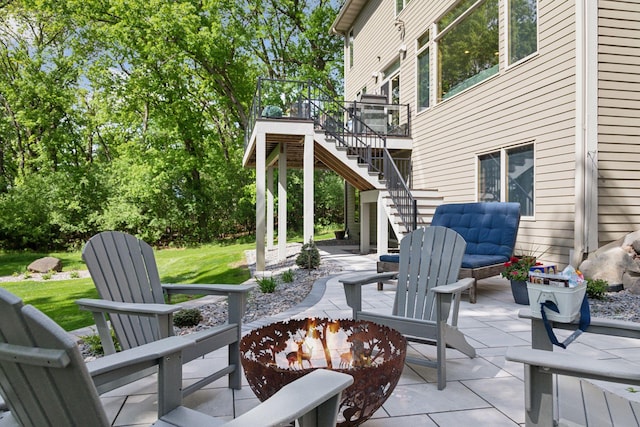 view of patio featuring stairs and a deck