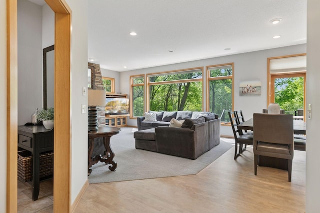 living area with recessed lighting and light wood-style flooring