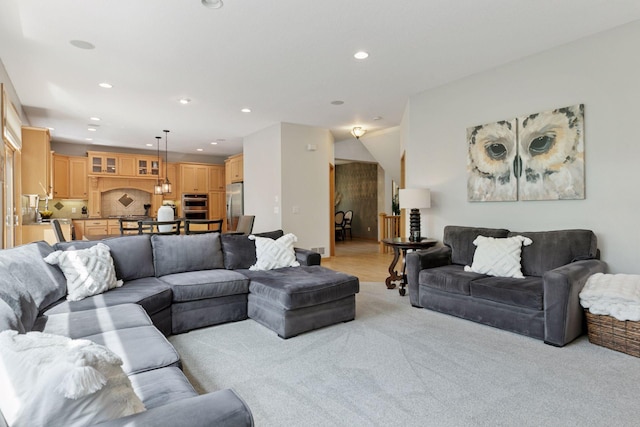 living room with recessed lighting and light carpet