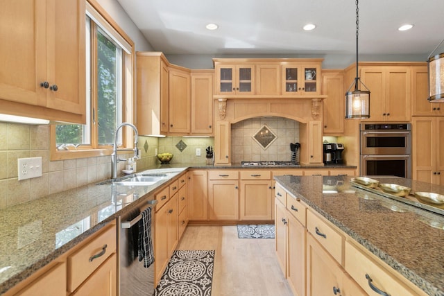 kitchen with a sink, appliances with stainless steel finishes, light brown cabinets, plenty of natural light, and recessed lighting