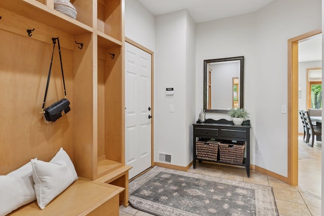mudroom with baseboards and tile patterned floors