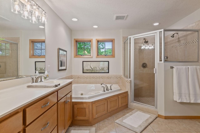 full bathroom with a shower stall, tile patterned floors, healthy amount of natural light, recessed lighting, and a textured ceiling
