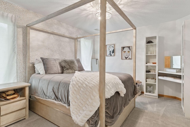 bedroom with light colored carpet and baseboards