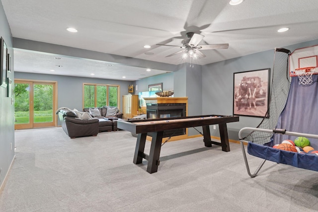 rec room with carpet floors, ceiling fan, a glass covered fireplace, recessed lighting, and baseboards