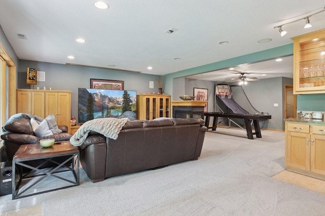 living room featuring light colored carpet, recessed lighting, ceiling fan, and rail lighting