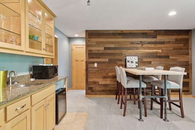 dining area with light colored carpet, wooden walls, recessed lighting, and wine cooler