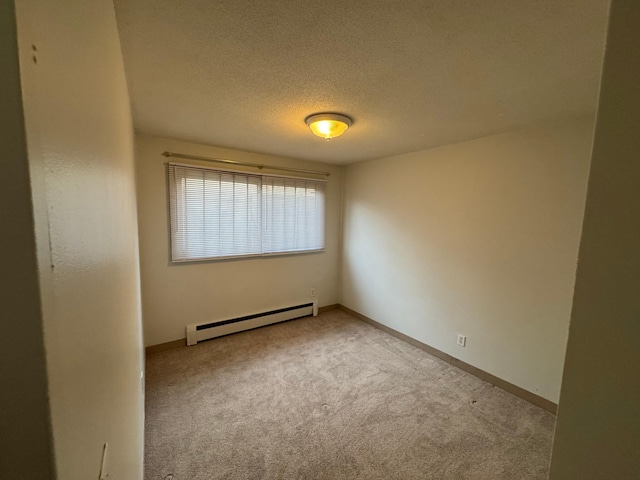spare room with carpet floors, a textured ceiling, baseboards, and baseboard heating