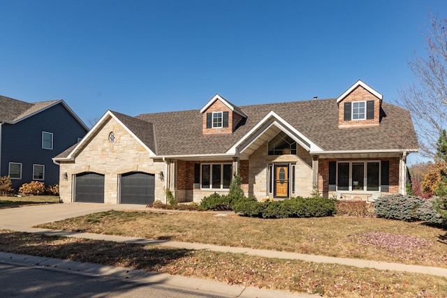 view of front of home with a garage, a shingled roof, concrete driveway, stone siding, and a front lawn