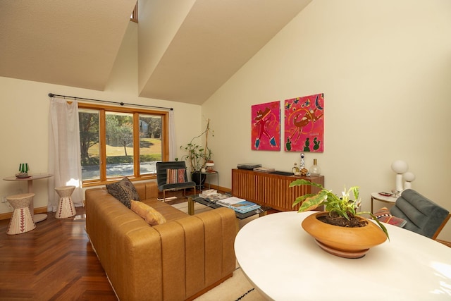 living room with baseboards and high vaulted ceiling